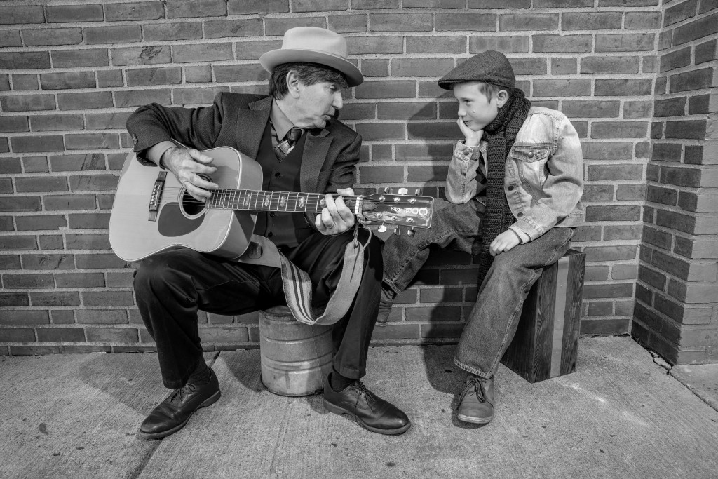 Tim Brown as the Narrator and Caden Mitchell as Tiny Tim. Photo by Rob Cuevas.